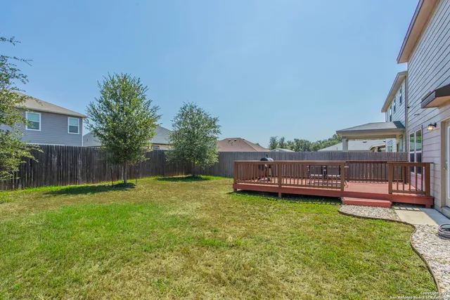 a view of a house with a yard and sitting area