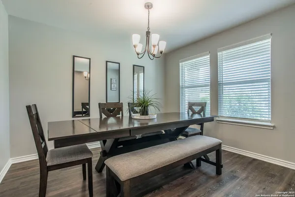 a kitchen with stainless steel appliances granite countertop a refrigerator a sink dishwasher a stove and white countertops with wooden floor