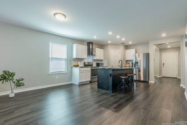 a kitchen with stainless steel appliances wooden cabinets and a stove a oven