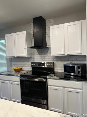 a bathroom with a granite countertop toilet sink and mirror