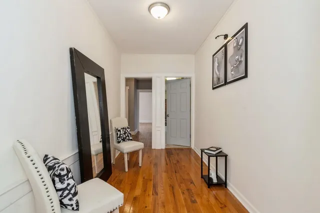 a view of a room with furniture and wooden floor