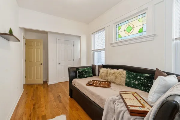 a bedroom with a bed and wooden floor