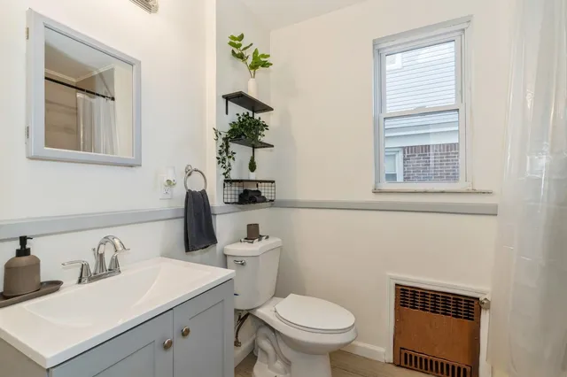 a bathroom with a toilet sink and mirror