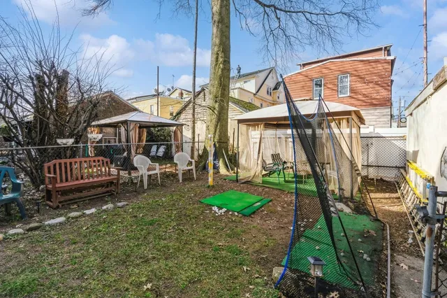 a view of a house with a yard and sitting area