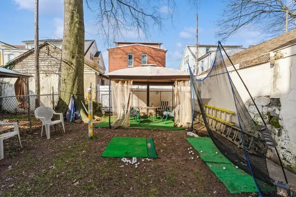 a view of a house with a yard and sitting area
