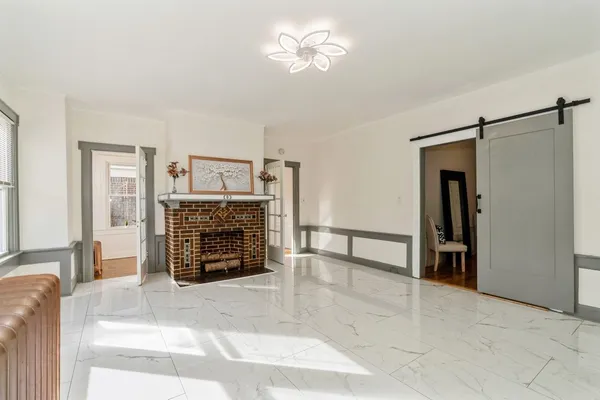 a view of an empty room with a fireplace