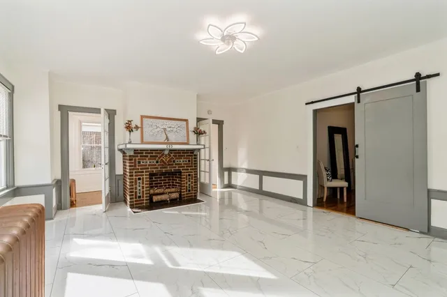 a view of an empty room with a fireplace