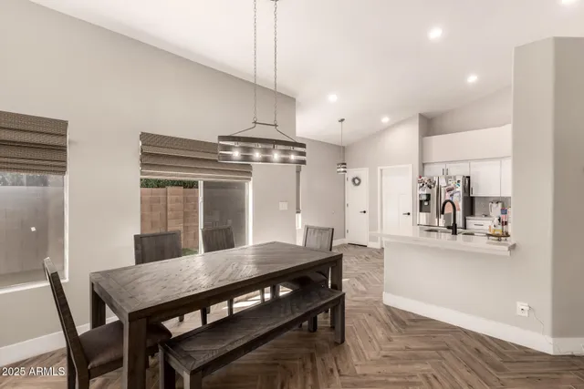 a view of a dining room with furniture and wooden floor