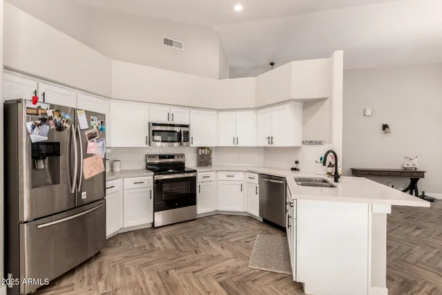 a kitchen with a sink stainless steel appliances and cabinets