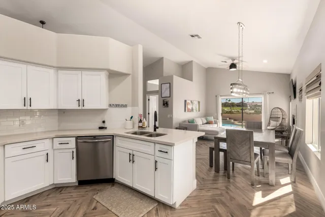 a view of a kitchen counter space a sink and appliances