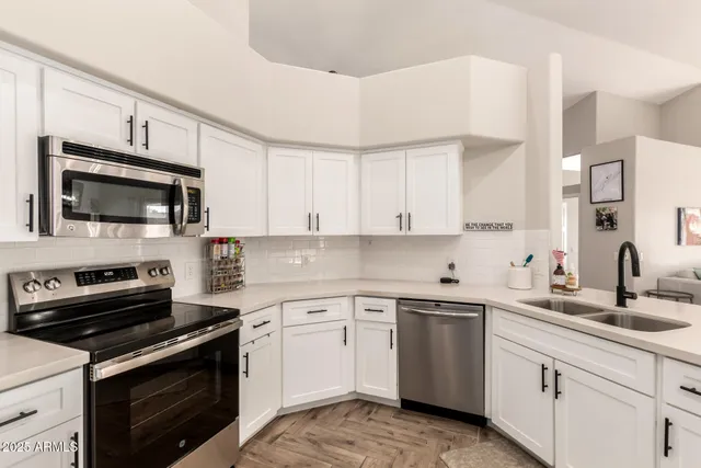a kitchen with a sink stove and microwave