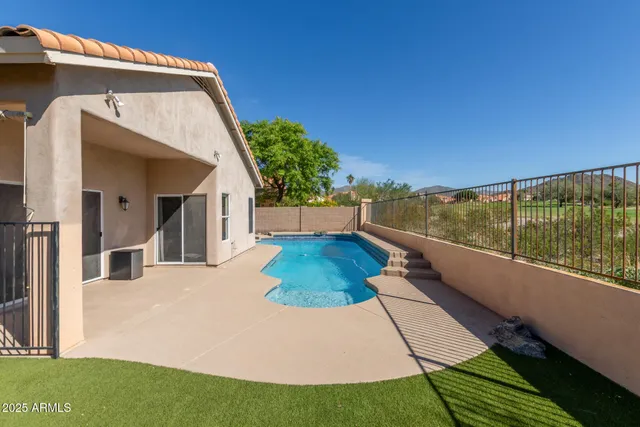 a view of a house with backyard and sitting area