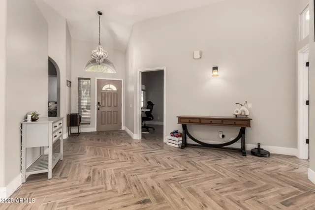 a view of a room with wooden floor and furniture