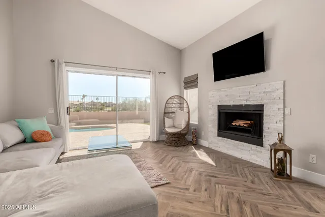 a living room with furniture a fireplace and a flat screen tv