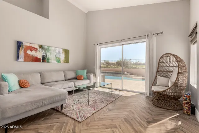 a living room with furniture and a large window with outer view