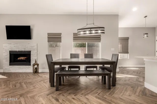 a view of a dining room with furniture wooden floor and chandelier