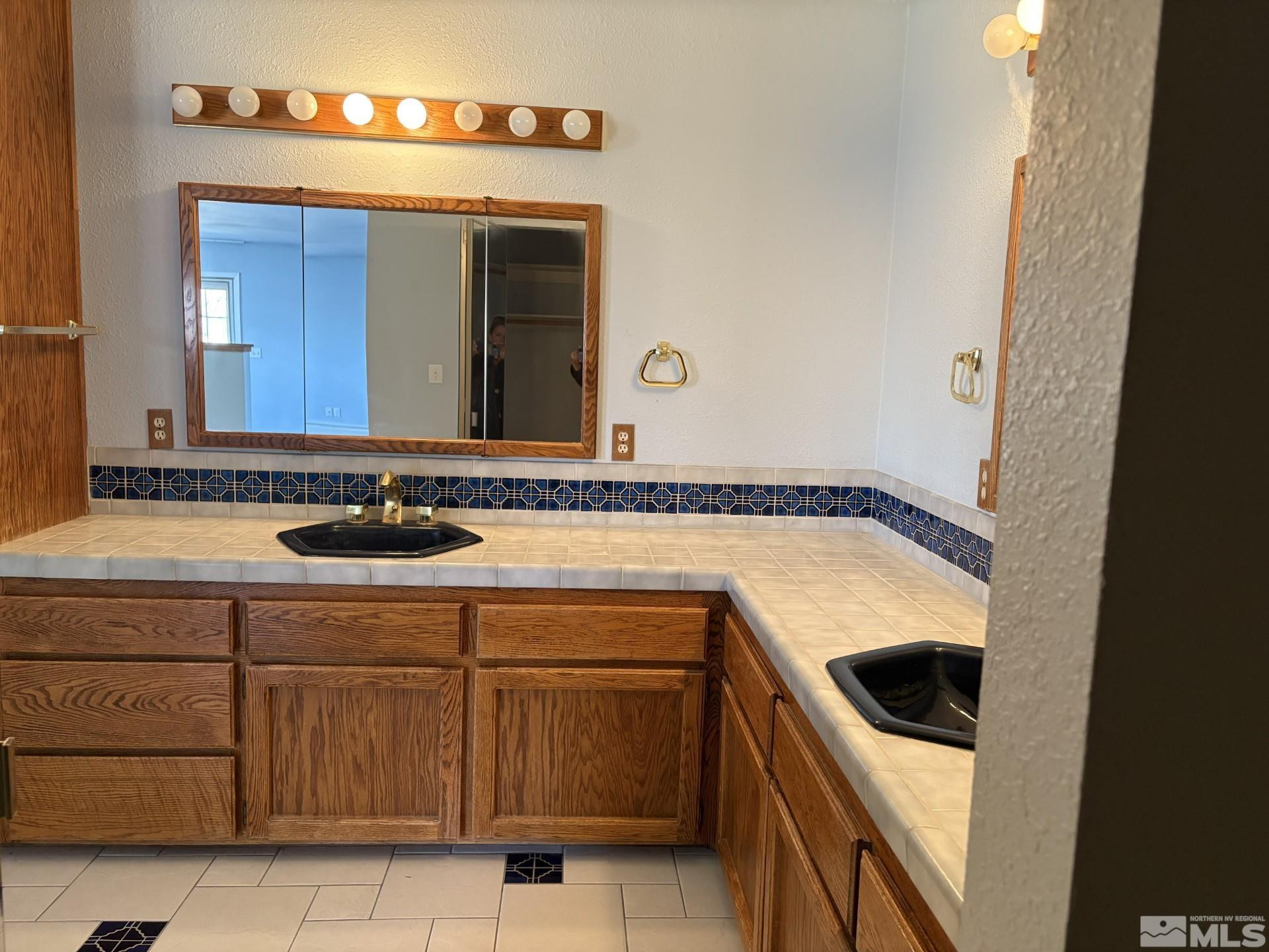 3 Comstock Circle Carson City, NV 89703 - Photo 19 of 30 a bathroom with a sink and a mirror