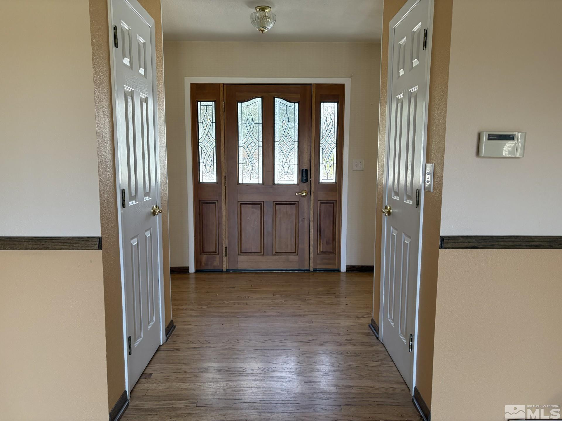 3 Comstock Circle Carson City, NV 89703 - Photo 4 of 30 a view of a hallway with wooden floor and a bathroom