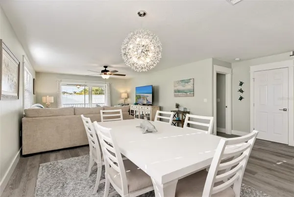 a view of a dining room with furniture and chandelier
