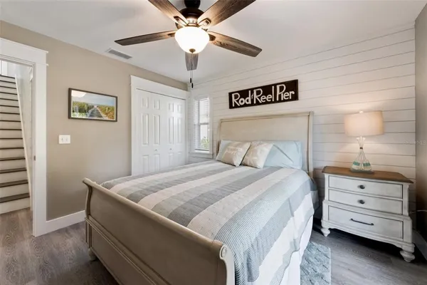 a bedroom with a bed and a chandelier