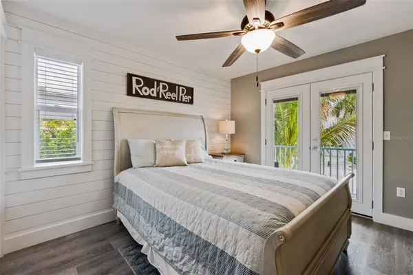 a bedroom with a large bed and a chandelier