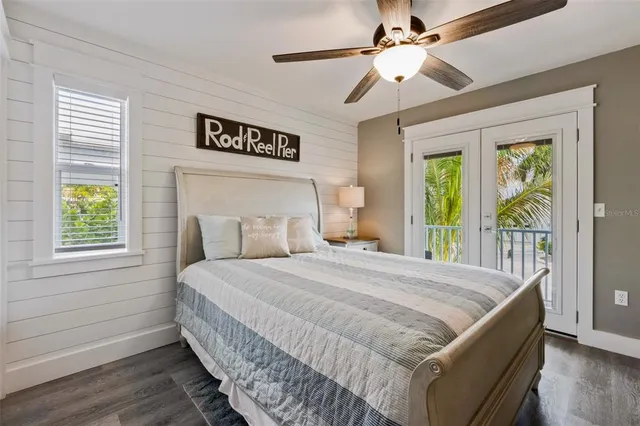 a bedroom with a large bed and a chandelier