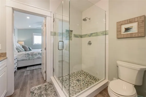 a bathroom with a sink toilet and shower