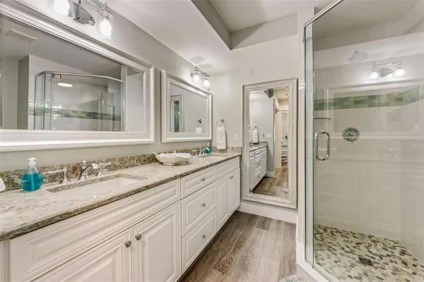 a bathroom with a granite countertop sink mirror and double