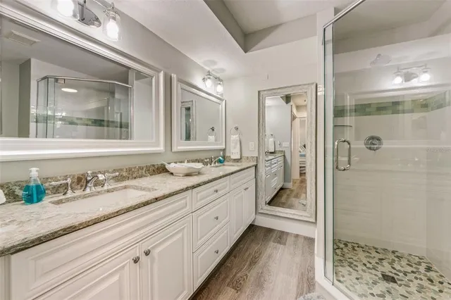 a bathroom with a granite countertop sink mirror and double
