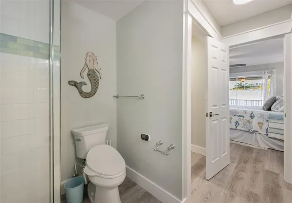 a bathroom with a toilet and a shower