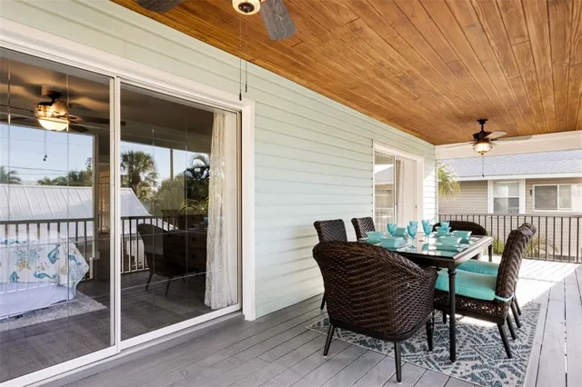 a view of a patio with table and chairs and potted plants