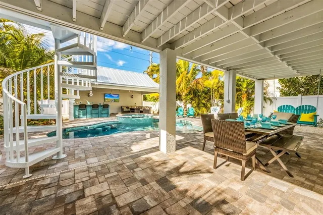 a view of a porch with furniture and garden