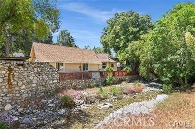 8 Oak Drive Mount Baldy, CA 91759 - Photo 11 of 26 a view of a wooden house with a yard