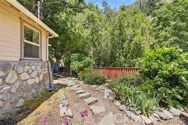 8 Oak Drive Mount Baldy, CA 91759 - Photo 5 of 26 a view of a backyard with a house and wooden fence