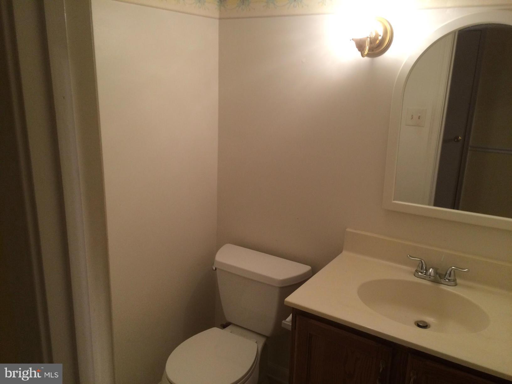 8575 Springfield Oaks Drive Springfield, VA 22153 - Photo 7 of 11 a bathroom with a sink toilet and mirror