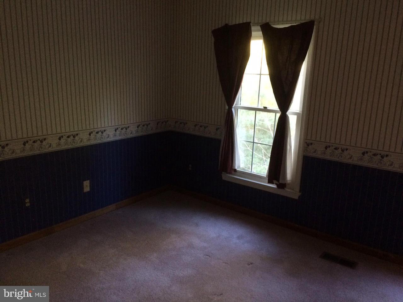 8575 Springfield Oaks Drive Springfield, VA 22153 - Photo 9 of 11 wooden floor in an empty room with a window