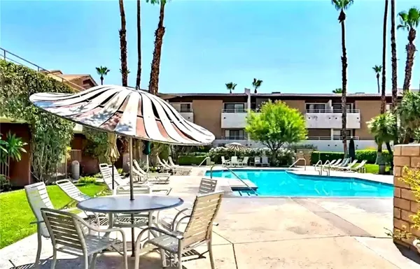 a view of a patio with table and chairs potted plants with wooden floor