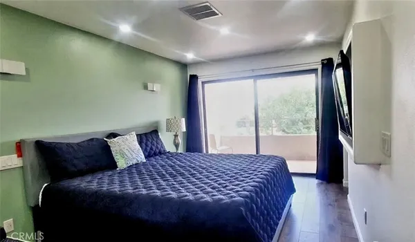 a bedroom with a large bed and a large window