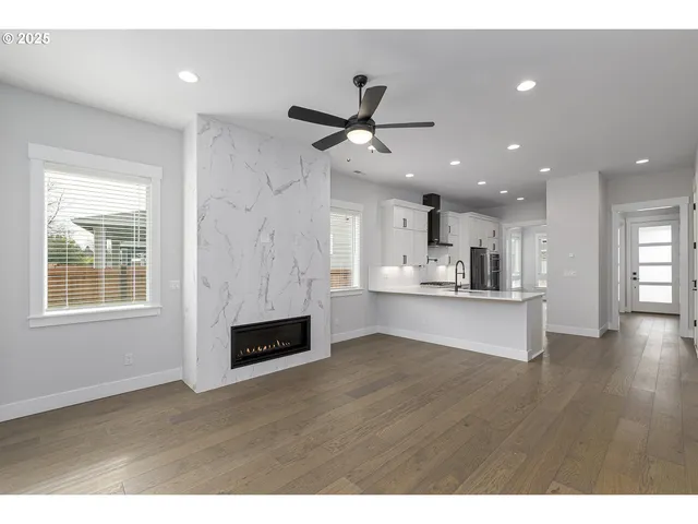 a view of kitchen with refrigerator and window