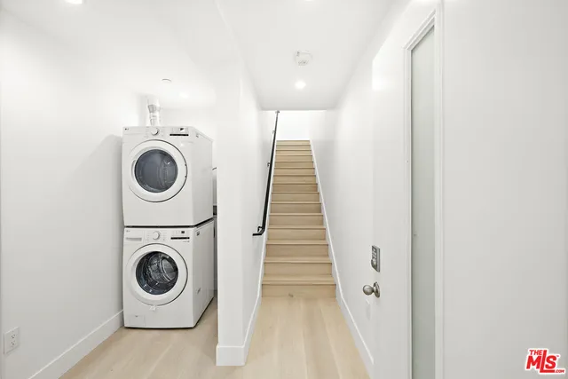 a view of a hallway with washer and dryer