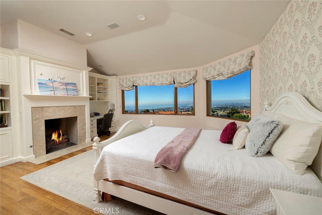 5 Sailview Newport Coast, CA 92657 - Photo 22 of 37 a spacious bedroom with a bed and a fireplace