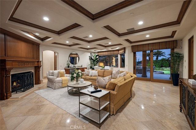 a living room with fireplace furniture and a dining table