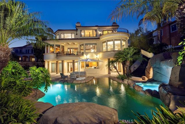 a view of a swimming pool with outdoor seating