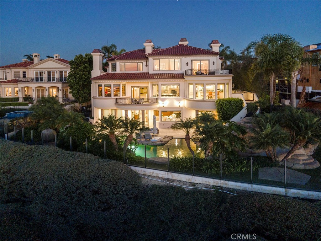 5 Sailview Newport Coast, CA 92657 - Photo 32 of 37 a front view of a residential apartment building with a yard