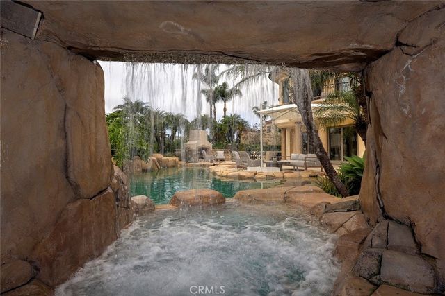 a view of a backyard of a house with a yard fire pit and outdoor seating