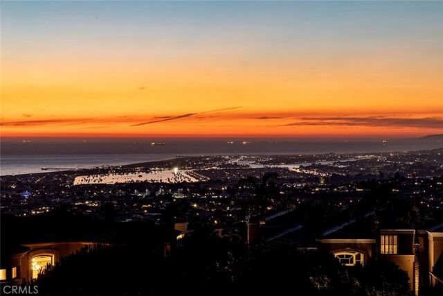 a view of a patio with couches table and chairs and potted plants