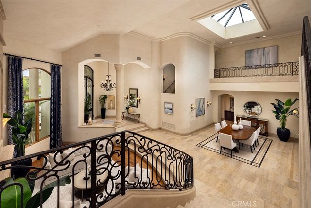 a view of a dining room with furniture and a chandelier
