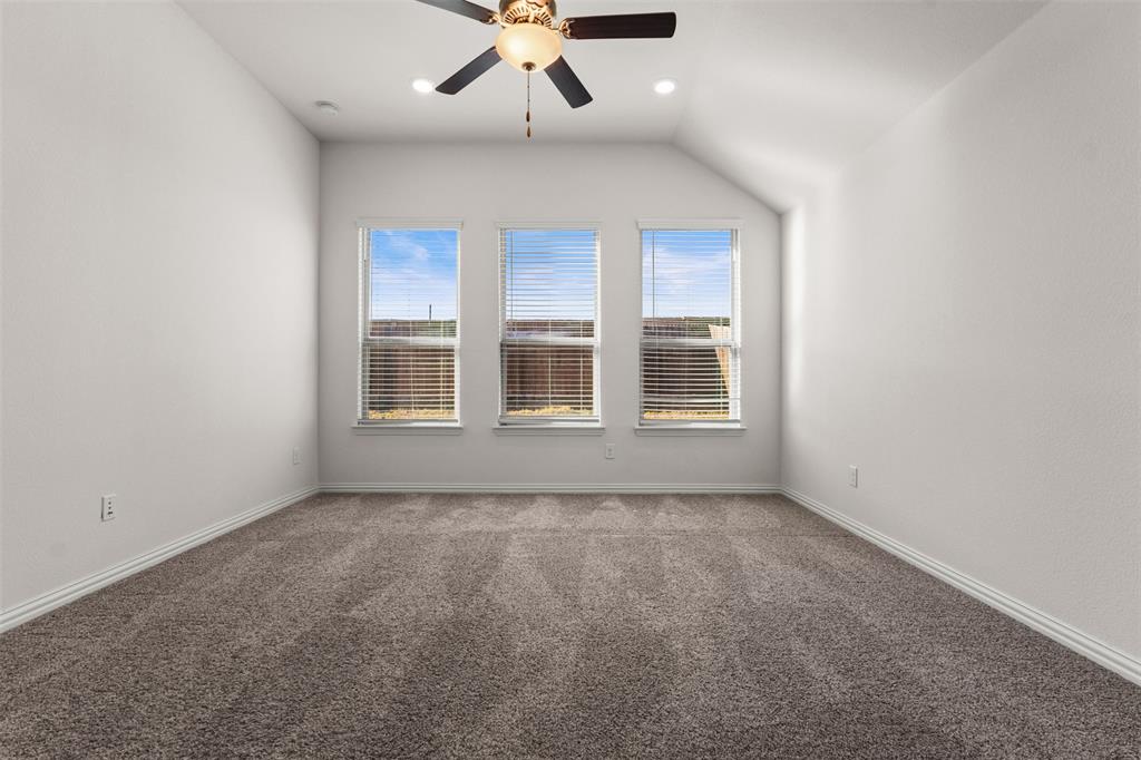 1740 Rio Costilla Road Fort Worth, TX 76131 - Photo 24 of 40 High vaulted ceiling with a ceiling fan, three windows with blinds, recessed lighting, and carpet flooring