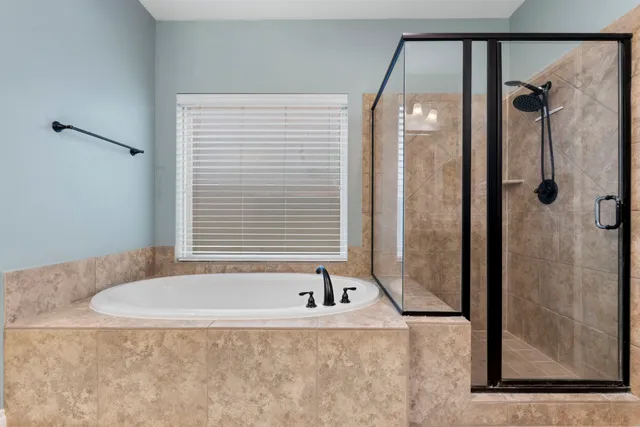 a bathroom with a tub and shower