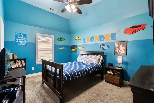 a bedroom with a bed and a chandelier